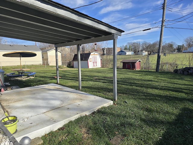 view of yard with a storage unit and a patio