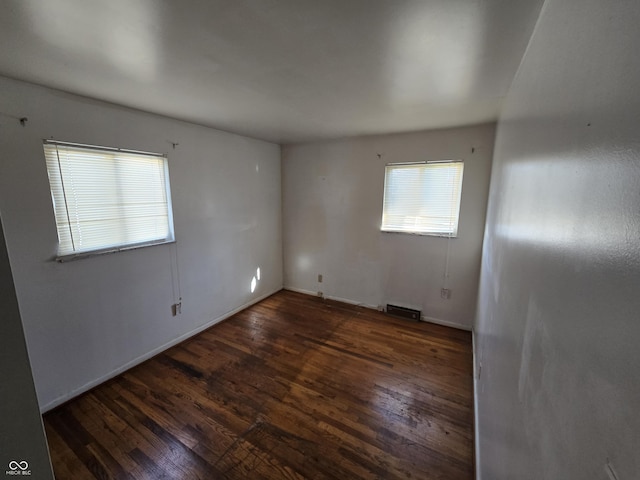 spare room featuring dark hardwood / wood-style flooring