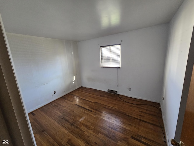 unfurnished room featuring dark hardwood / wood-style flooring