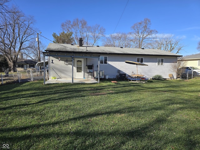 rear view of property featuring a yard