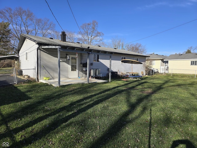 rear view of house with a yard and a patio area