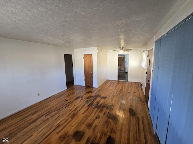 unfurnished room featuring dark hardwood / wood-style flooring and a textured ceiling