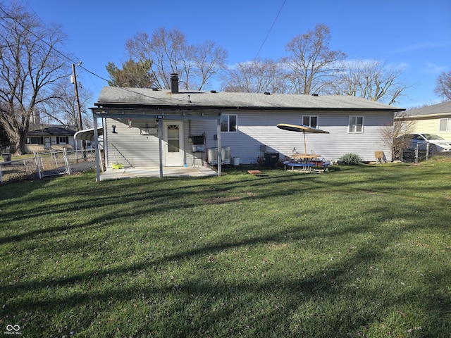 back of house featuring a patio area and a yard