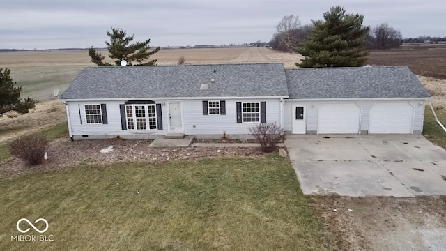 view of front of home with a front yard and a garage