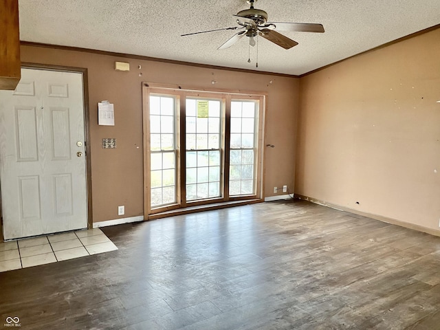 interior space with ceiling fan, light wood-type flooring, ornamental molding, and a textured ceiling