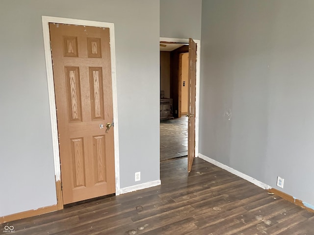 spare room with dark wood-type flooring