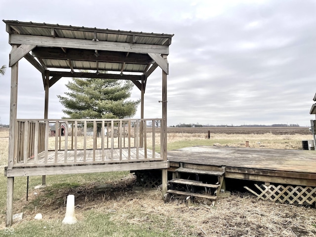 wooden terrace featuring a rural view