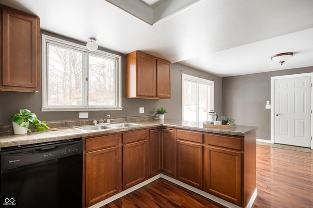 kitchen with dishwasher, dark wood-type flooring, a healthy amount of sunlight, sink, and kitchen peninsula