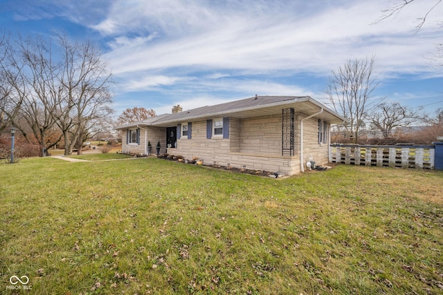 rear view of property featuring a yard