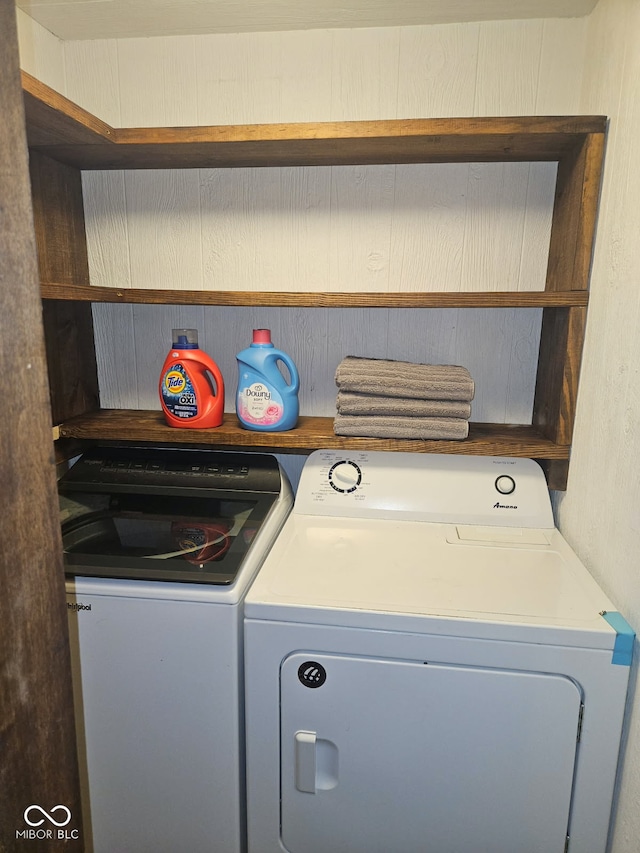 clothes washing area with washing machine and dryer