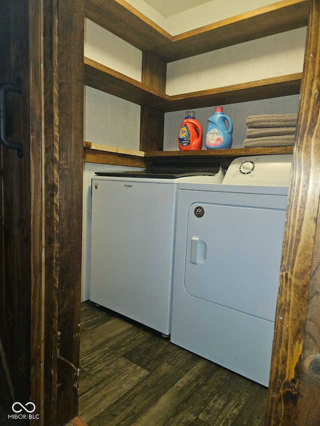 clothes washing area featuring dark hardwood / wood-style flooring and washing machine and clothes dryer