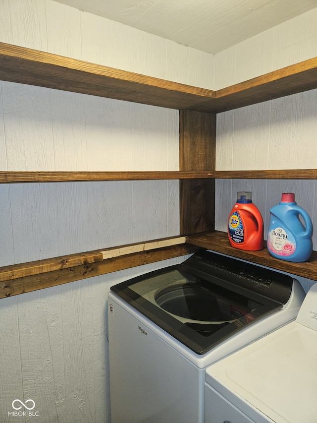 clothes washing area with washing machine and clothes dryer