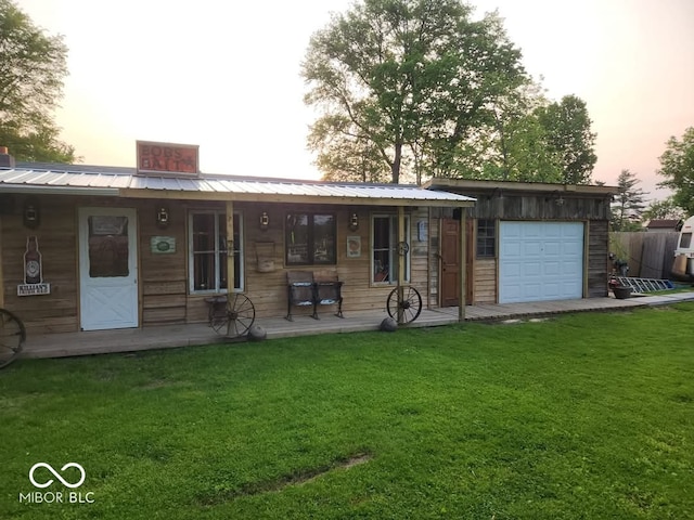 back house at dusk with a lawn