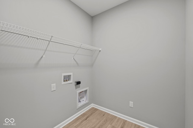 clothes washing area featuring washer hookup and hardwood / wood-style flooring