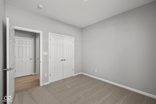 unfurnished bedroom featuring carpet and a closet