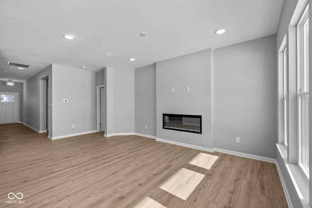 unfurnished living room with light hardwood / wood-style floors