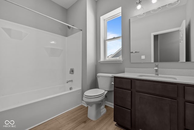 full bathroom with bathtub / shower combination, toilet, vanity, and wood-type flooring