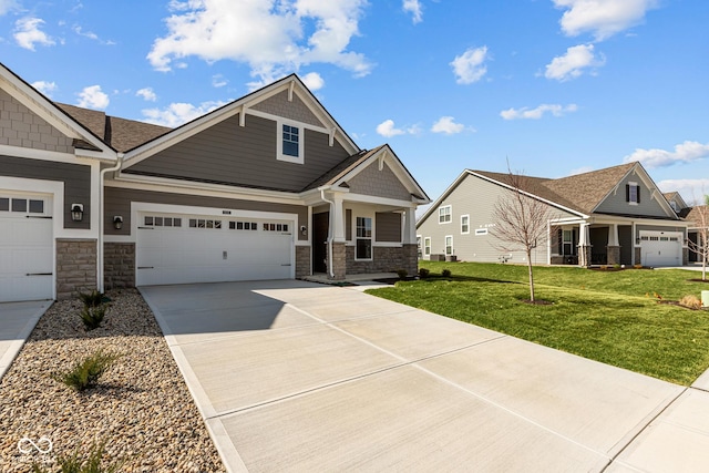 16689 Cattle Hollow Ln, Noblesville, IN 46060 - craftsman-style house featuring stone siding, driveway, a garage, and a front lawn