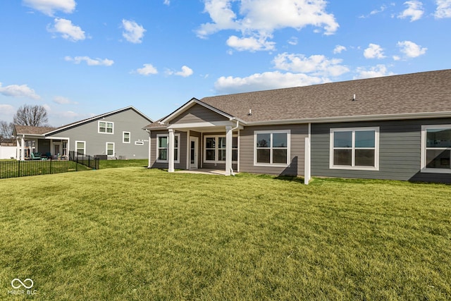 16689 Cattle Hollow Ln, Noblesville, IN 46060 - back of house featuring fence, a shingled roof, a yard, and a patio area