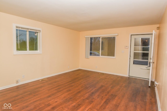 spare room featuring dark hardwood / wood-style flooring