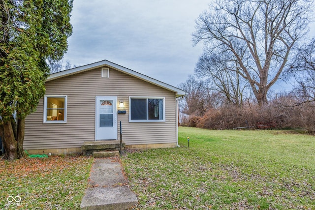 bungalow-style house featuring a front yard