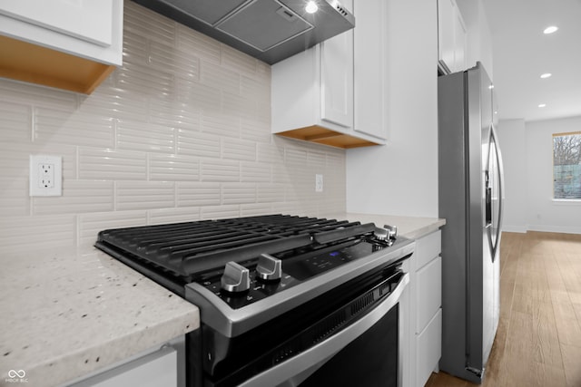 kitchen with custom exhaust hood, backsplash, white cabinetry, gas stove, and stainless steel fridge with ice dispenser