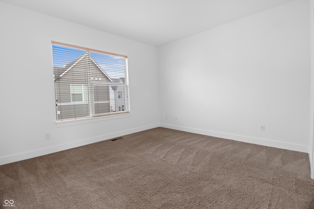 spare room featuring carpet floors