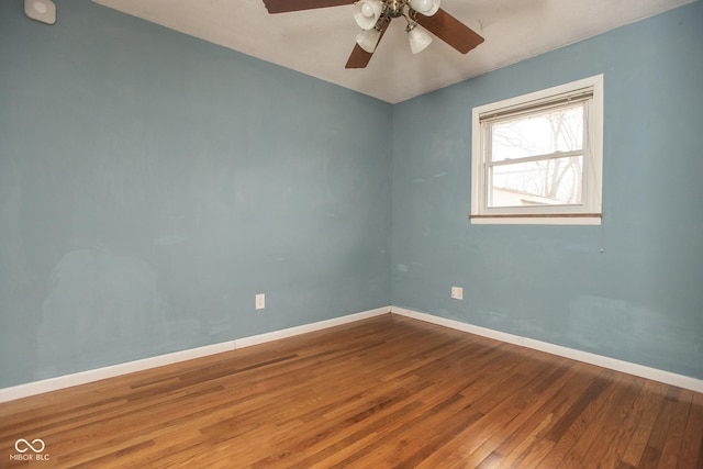 empty room with ceiling fan and hardwood / wood-style flooring