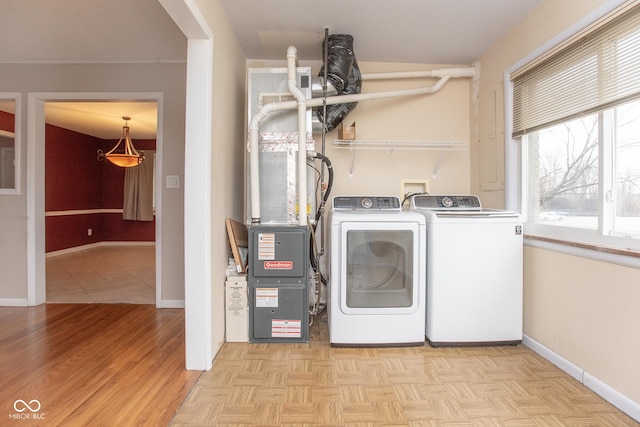 laundry area with light parquet floors and washer and clothes dryer