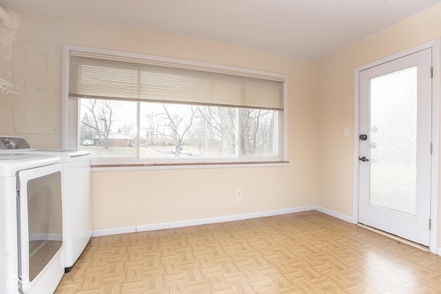 washroom featuring washer and clothes dryer, a wealth of natural light, and light parquet flooring