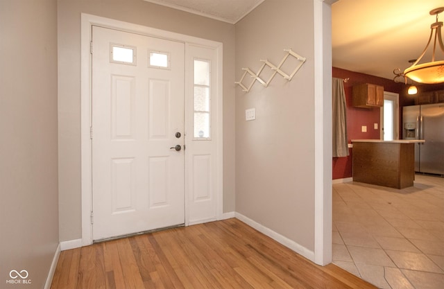 entryway featuring light hardwood / wood-style flooring and ornamental molding