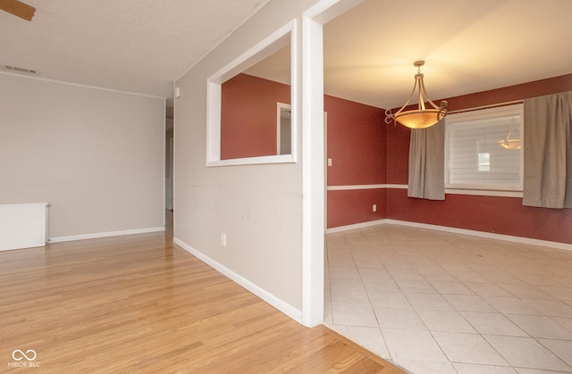 unfurnished room with light wood-type flooring