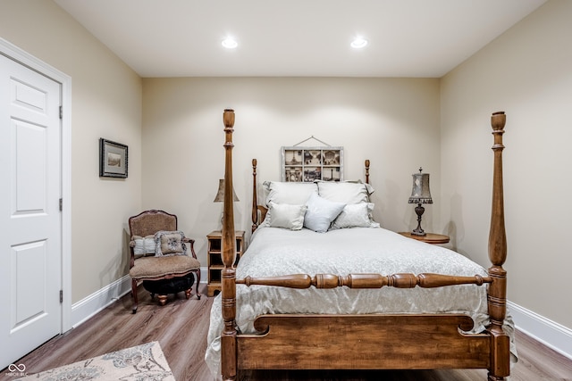 bedroom with hardwood / wood-style floors