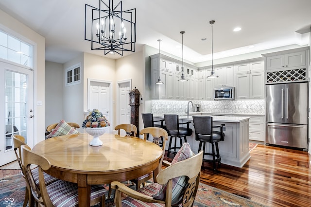 dining area featuring a notable chandelier and hardwood / wood-style floors