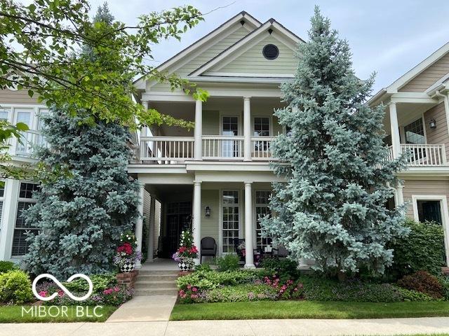 greek revival inspired property featuring a balcony