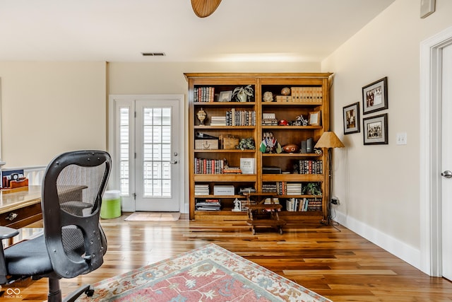 office with wood-type flooring