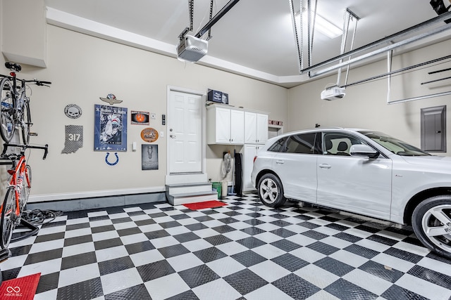 garage with a garage door opener and electric panel