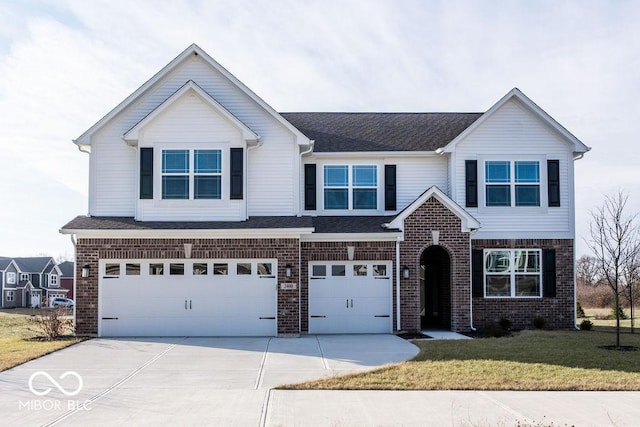 view of front of property with a front yard and a garage