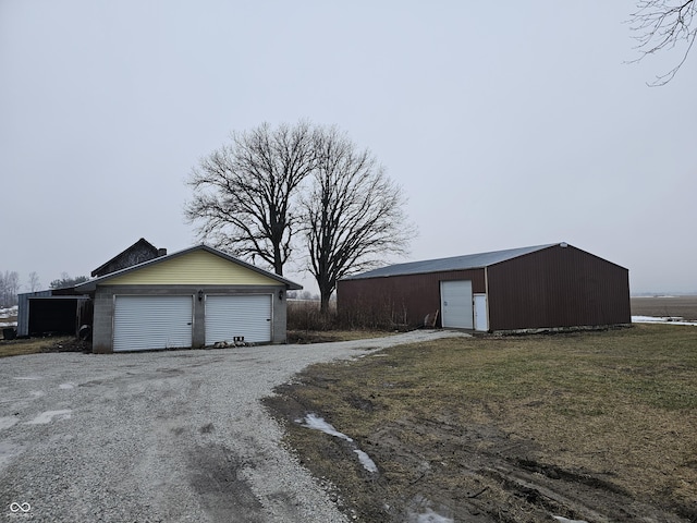 view of side of home featuring an outbuilding and a garage