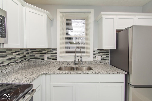 kitchen with white cabinetry, sink, and stainless steel appliances