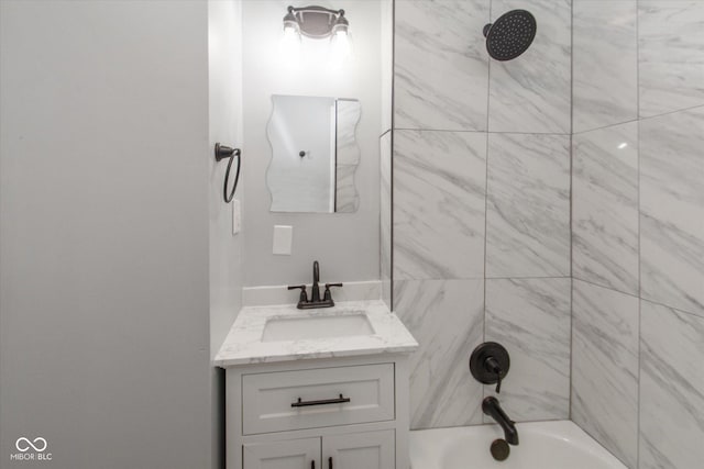 bathroom featuring vanity and tiled shower / bath combo