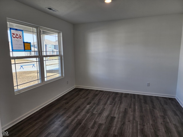 spare room with dark hardwood / wood-style floors