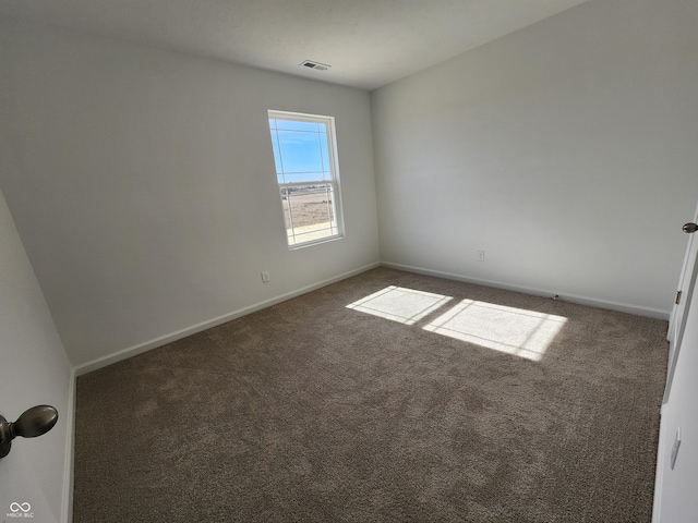 unfurnished room with dark carpet