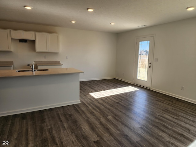 kitchen with sink, white cabinets, and dark hardwood / wood-style floors