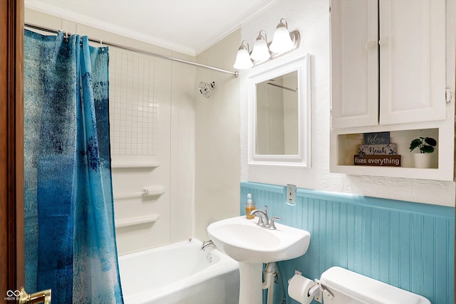 bathroom featuring crown molding, wooden walls, shower / bath combo, and toilet