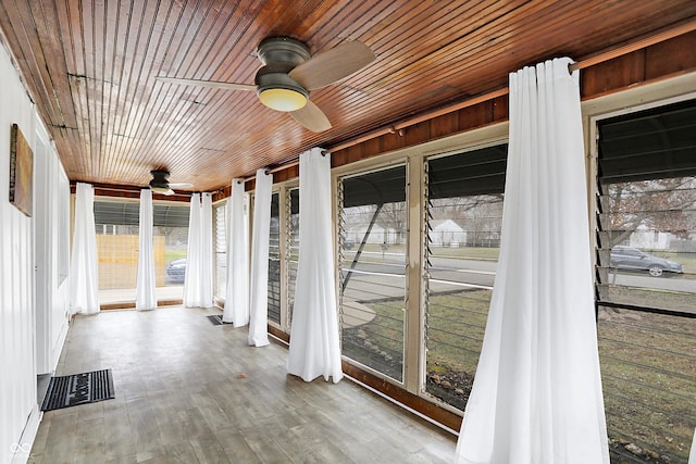 unfurnished sunroom featuring ceiling fan and wood ceiling