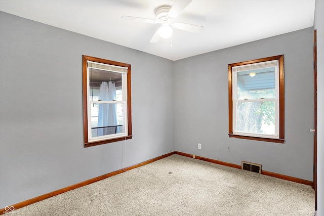 carpeted empty room featuring ceiling fan