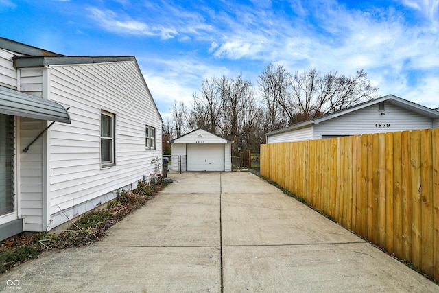 view of side of home featuring a garage and an outdoor structure