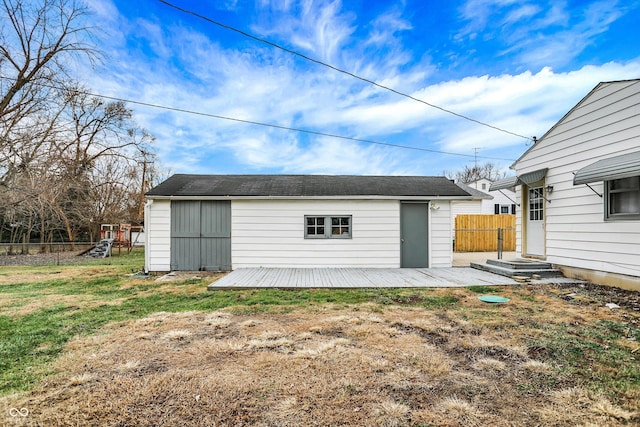 exterior space featuring a yard, an outdoor structure, and a deck