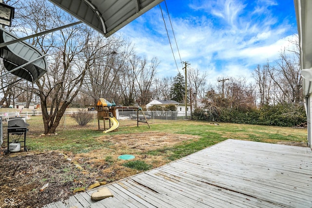 deck featuring a playground, area for grilling, and a lawn